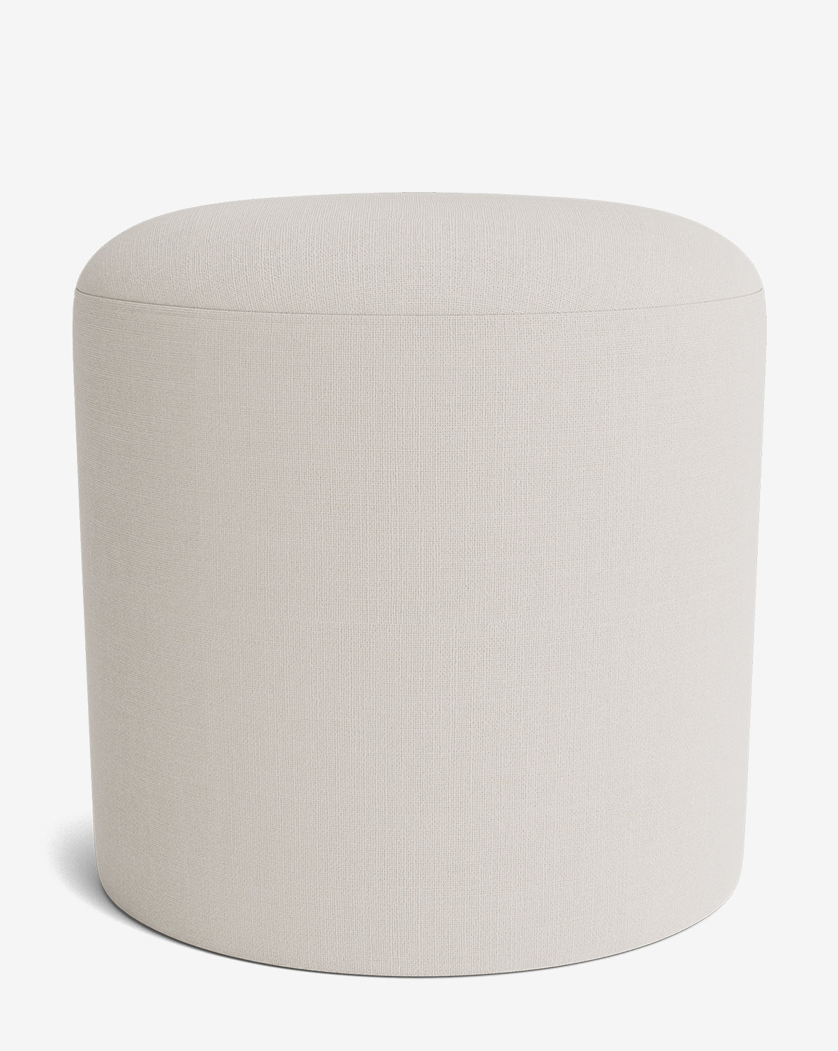 The Makerspalm Bellamy Ottoman is a minimalist, round ottoman in light beige fabric with a seamless surface and no visible legs or details, perfect for modern spaces. McGee & Co.