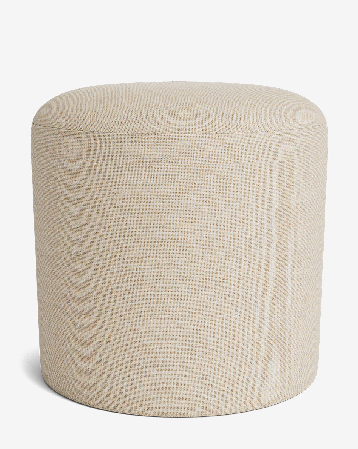 The Makerspalm Bellamy Ottoman is a round, beige fabric piece with a smooth top and cylindrical shape, shown against a plain white background. McGee & Co.