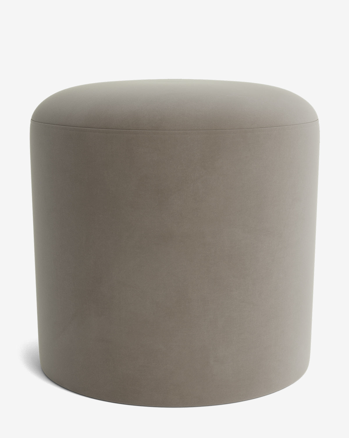 The Makerspalm Bellamy Ottoman features smooth taupe upholstery in a round, minimalist design with no visible legs or decorations, shown against a plain white background. McGee & Co.