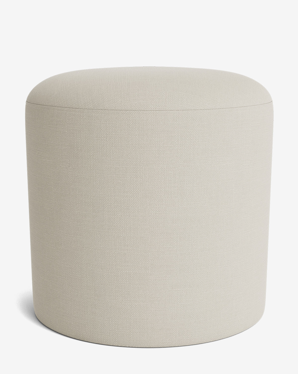 The Makerspalm Bellamy Ottoman is a simple, round piece in light beige with smooth upholstered fabric and no visible legs, shown against a white background. McGee & Co.
