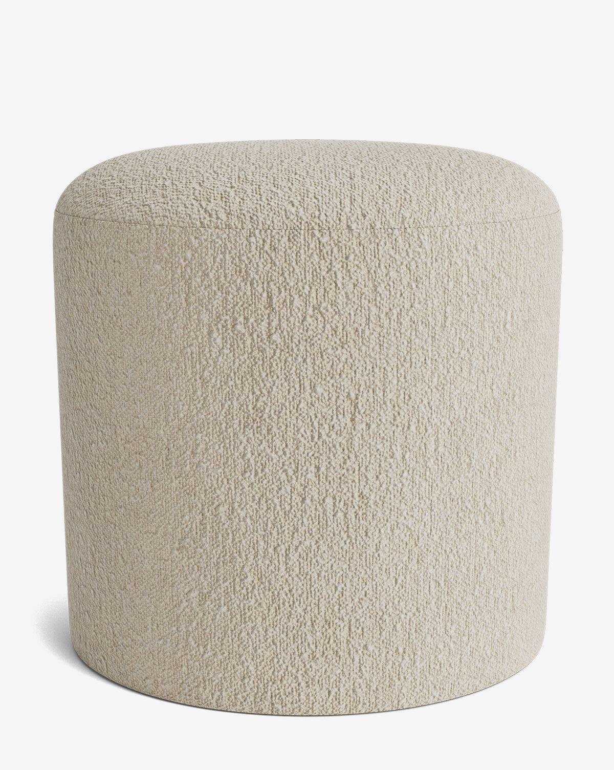 The Makerspalm Bellamy Ottoman is a round, light beige ottoman with a textured fabric surface. Its simple, modern design without visible legs makes it a versatile accent for any space. Shown against a plain white background. McGee & Co.