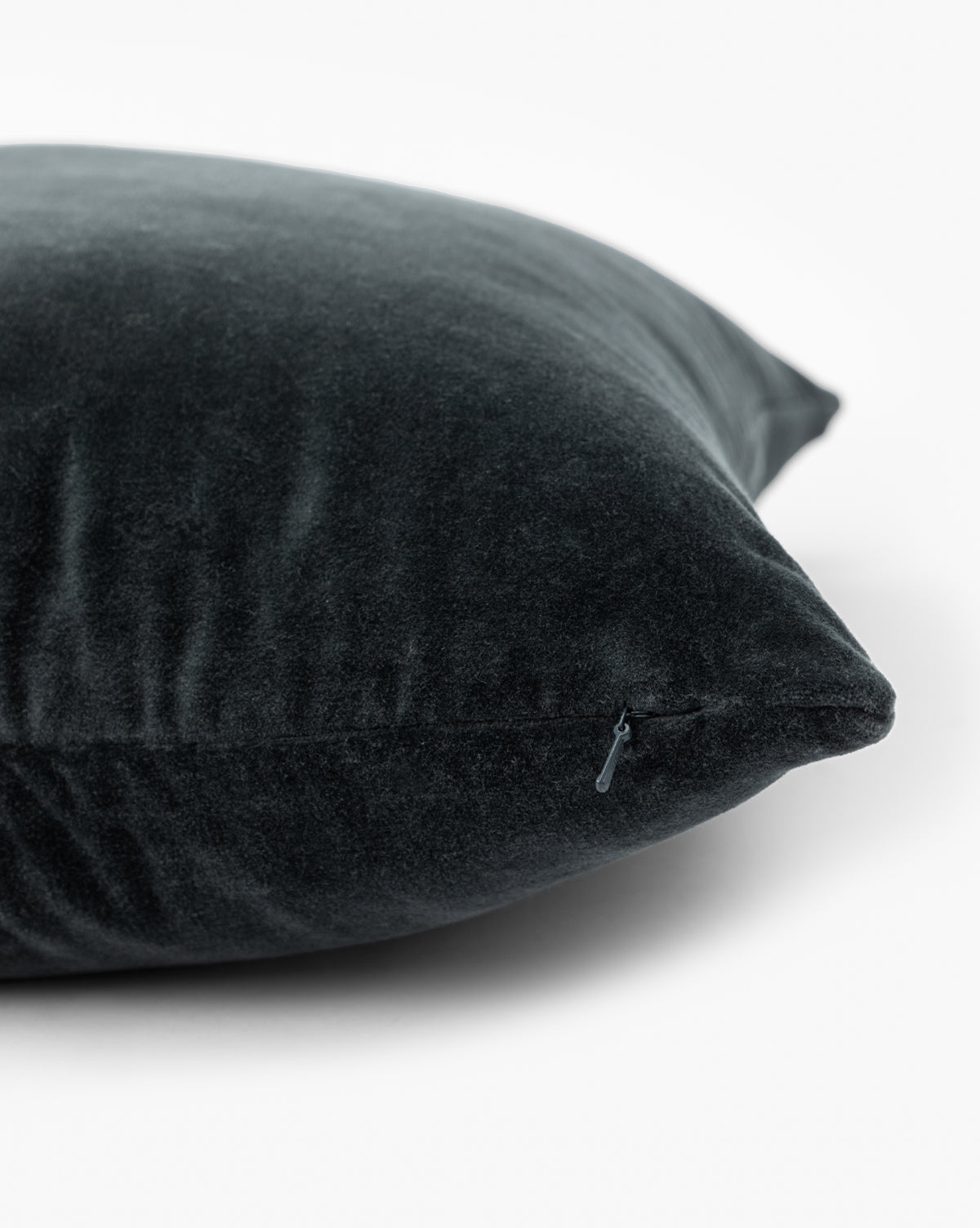 Close-up of the Bellevue Velvet Pillow Cover in dark gray stone-washed velvet, featuring a visible zipper, by McGee & Co.