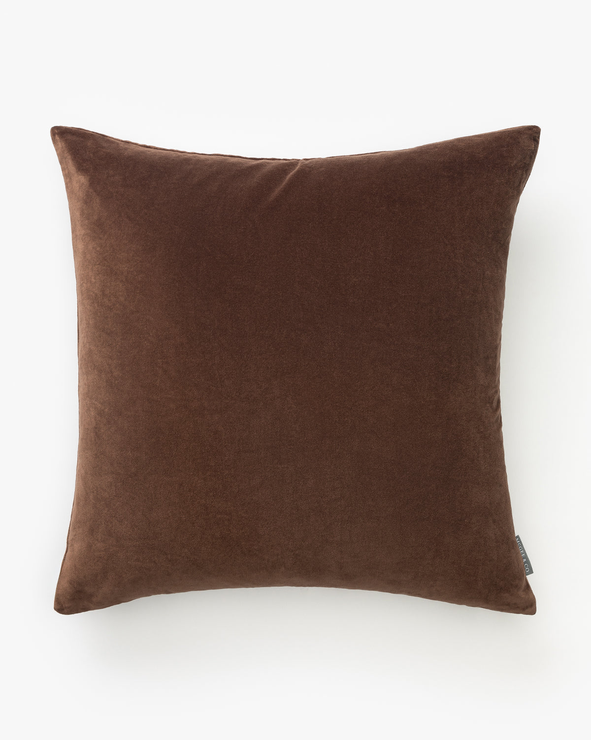 The Bellevue Velvet Pillow Cover, in a rich brown with a soft velvet texture, is displayed against a white background—the perfect decorative accent to elevate any space, by McGee & Co.