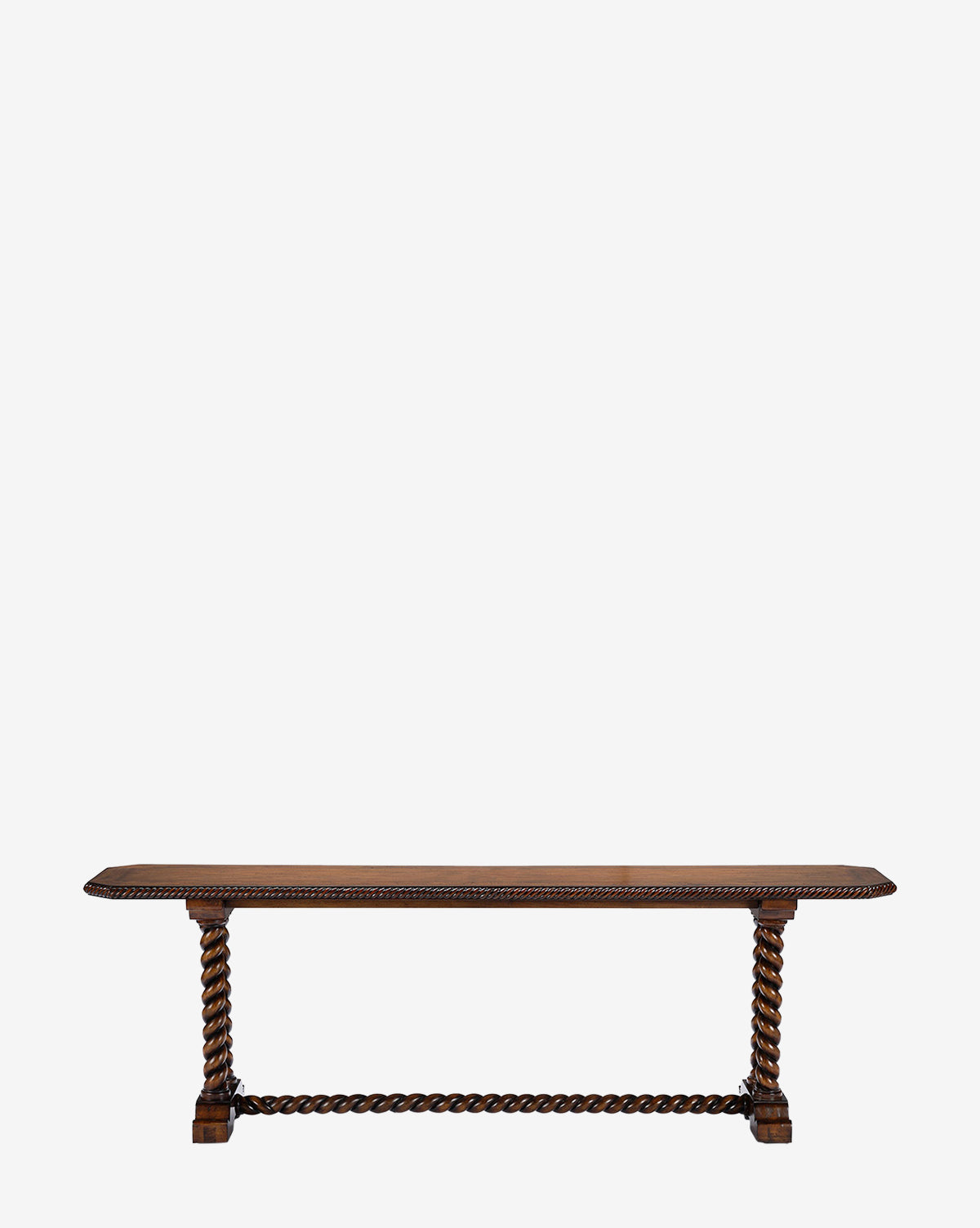 The Bennett Console is a long, rectangular antique table with intricately carved twisted legs and a matching stretcher, crafted from dark polished mahogany wood. It stands against a plain white background by McGee & Co.