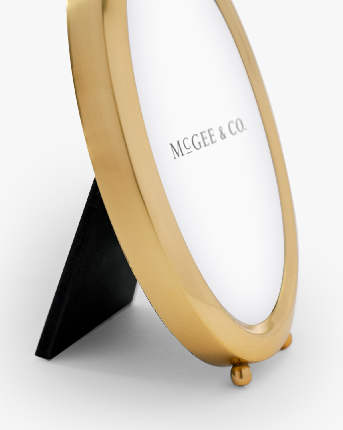 Its gold oval design beautifully displays your favorite memories with timeless style, by McGee & Co.