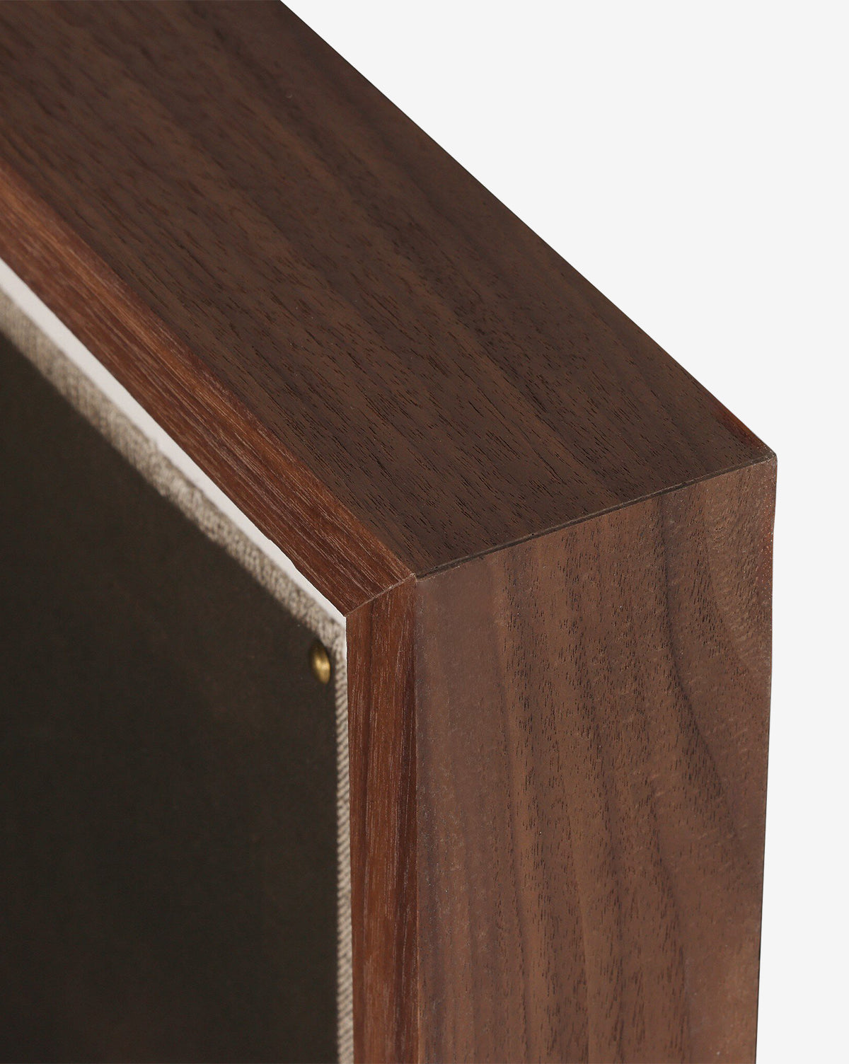 Close-up of a handmade wooden picture frame with a dark finish, securing Bloom II by Brittney Schulz on canvas inside, fastened neatly with a small brass tack, by McGee & Co.