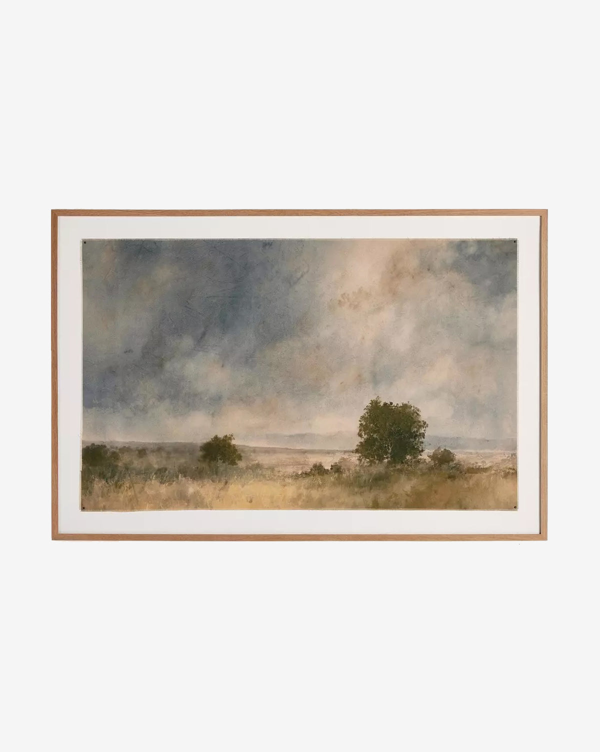 Blue Spendor by Aileen Fitzgerald is a framed landscape featuring a grassy field, trees, and a dramatic sky. Muted earth tones and soft blues evoke calm, enhanced by an elegant white oak frame.