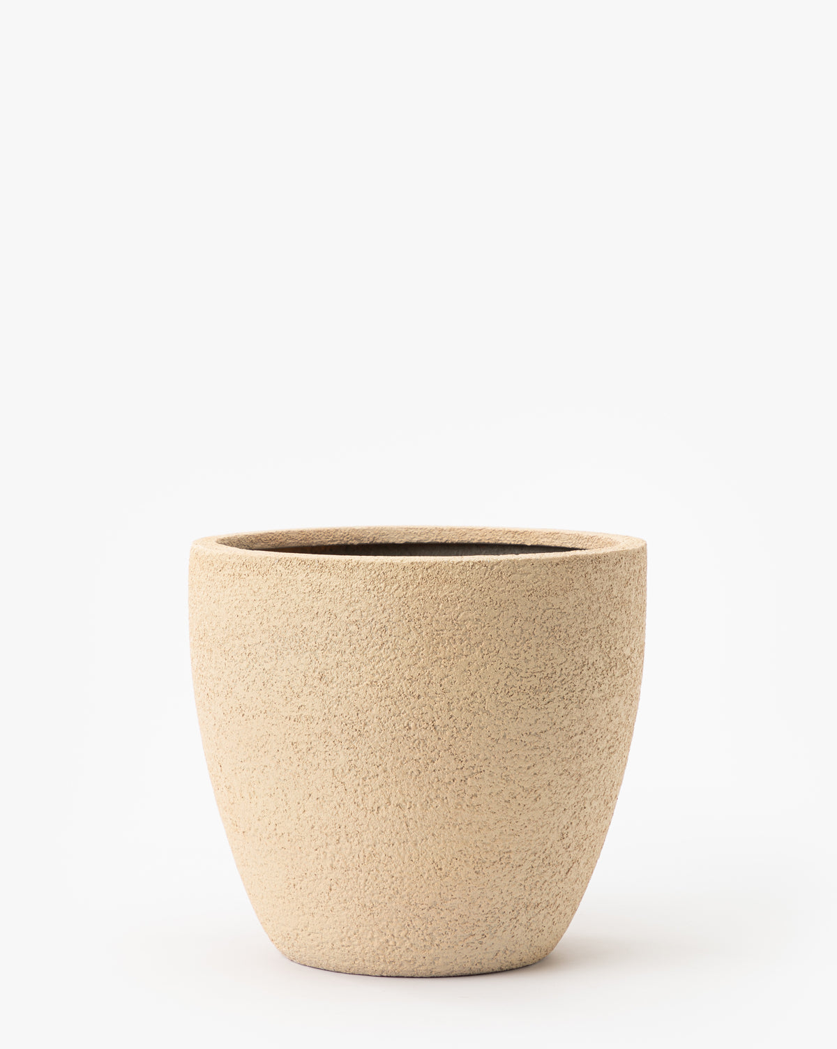 The Bodie Tan Fiberstone Planter features a beige, textured finish, wide opening, and round shape. It’s weatherproof for outdoor use and shown against a plain white background.