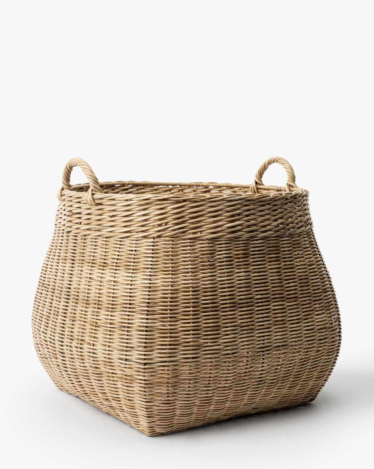The Boyce Woven Basket is a large, square wicker storage basket with two looped handles on opposite sides, displayed against a plain white background by McGee & Co.