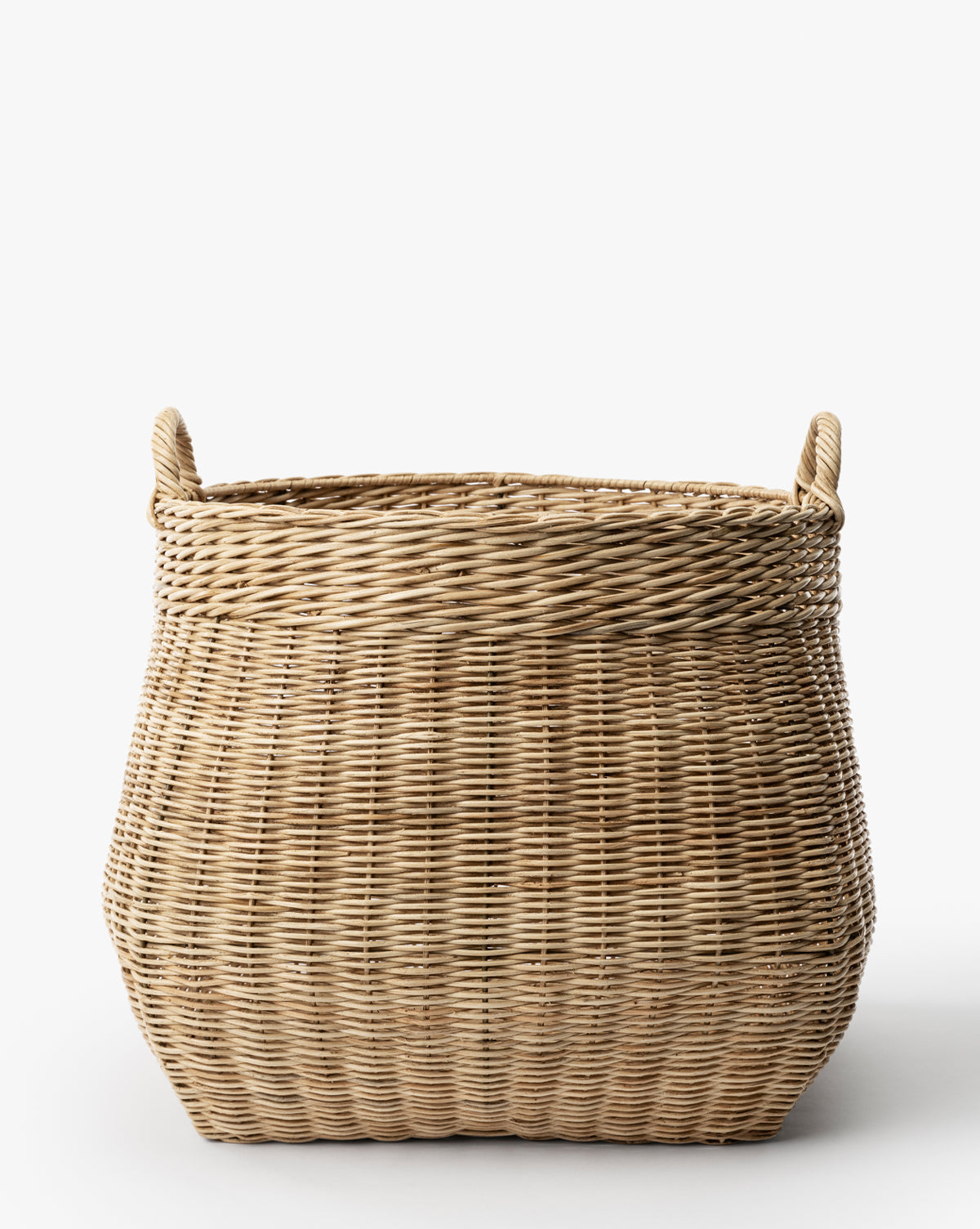 The Boyce Woven Basket is a large, rectangular wicker storage basket featuring two looped handles on each side, displayed against a plain white background by McGee & Co.