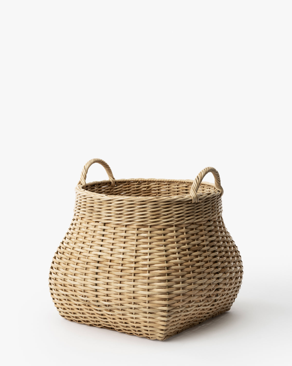 The Boyce Woven Basket is a large, square wicker storage basket featuring two looped handles on opposite sides, shown against a plain white background, by McGee & Co.
