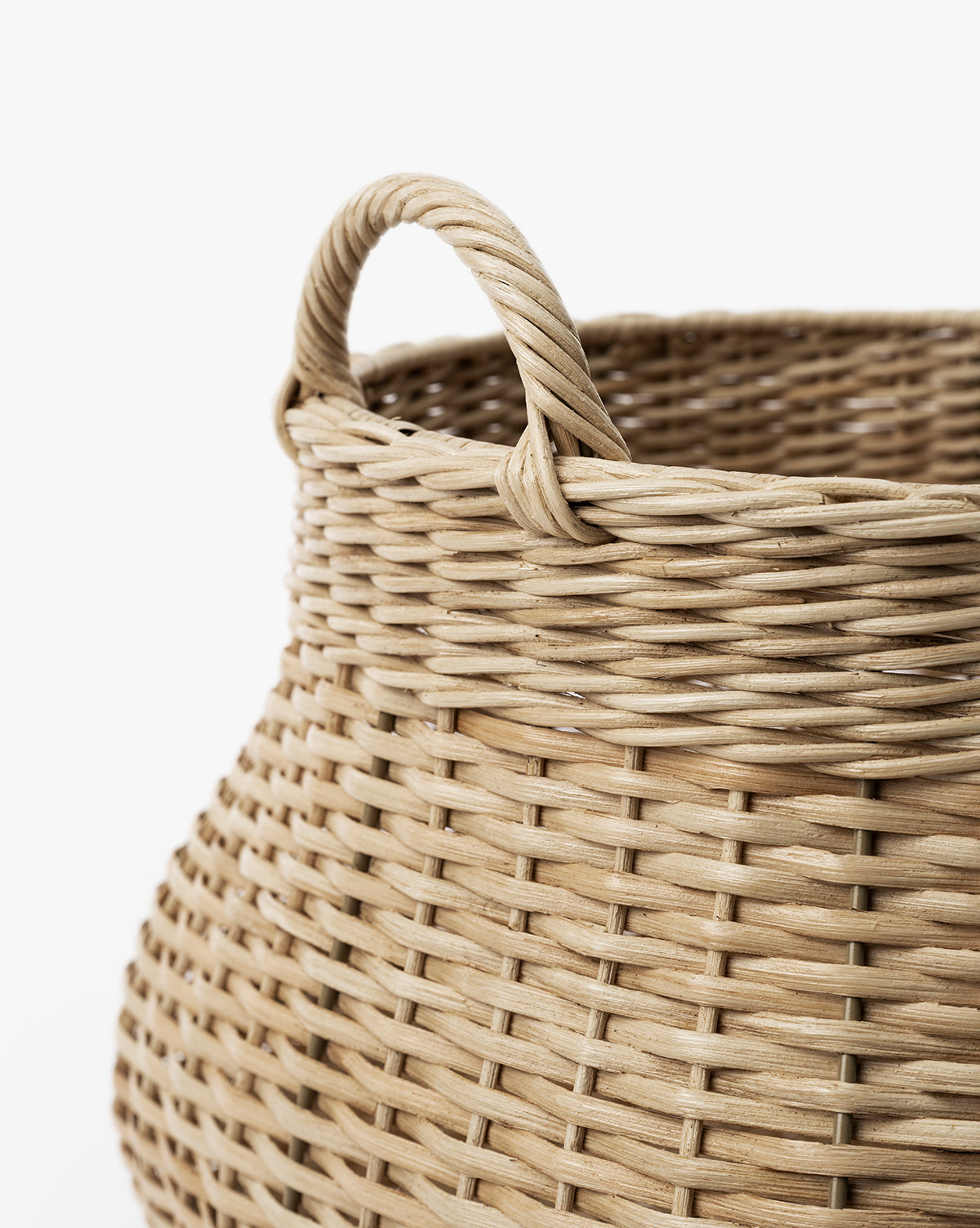 Close-up of the Boyce Woven Basket, crafted from light-colored natural fibers with a sturdy handle and intricate weaving patterns, shown against a white background, by McGee & Co.