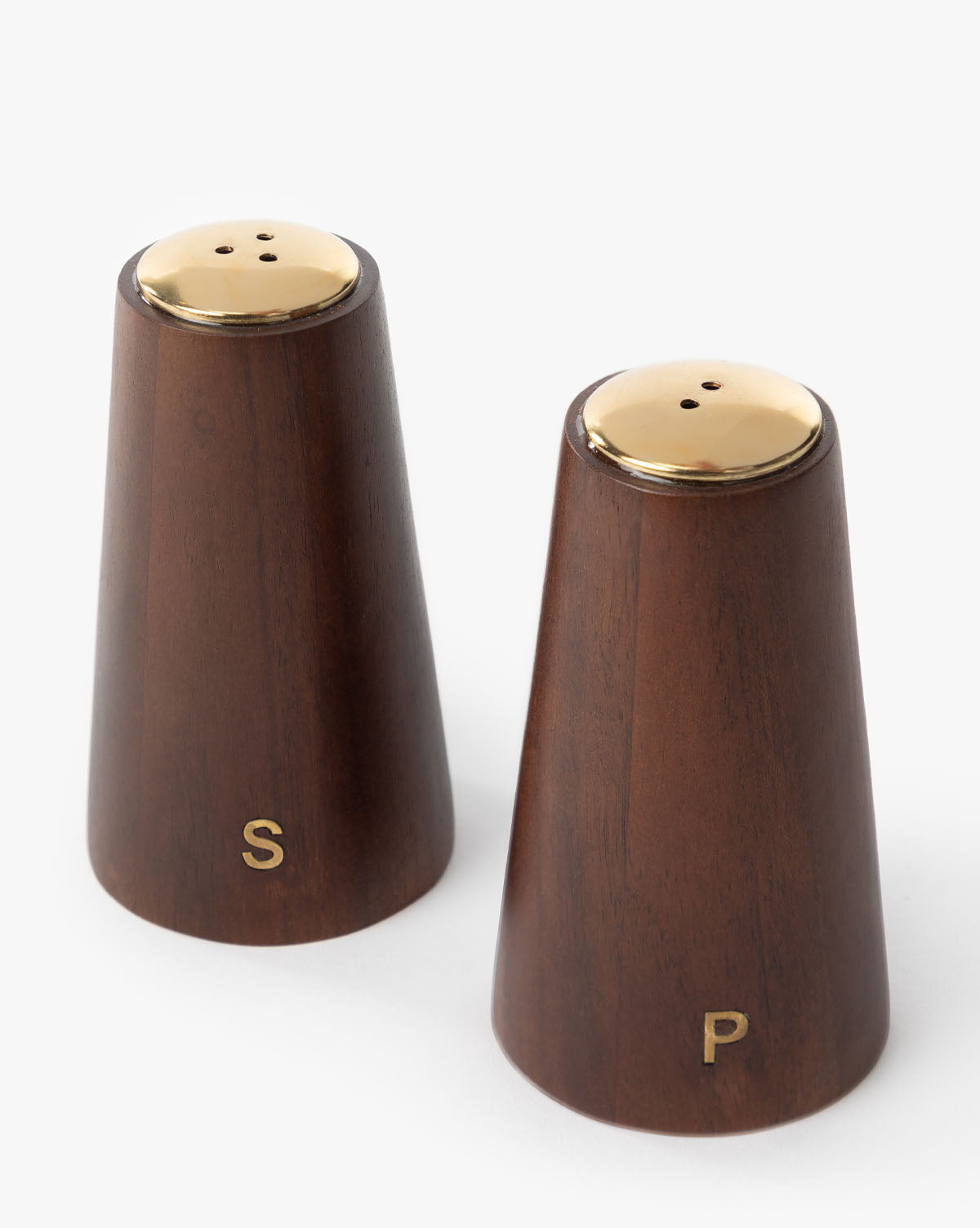 The Brasserie Salt & Pepper Shakers (Set of 2) feature gold tops and S and P letters on wooden bodies, sitting side by side on a white background for classic French café style in your kitchen.