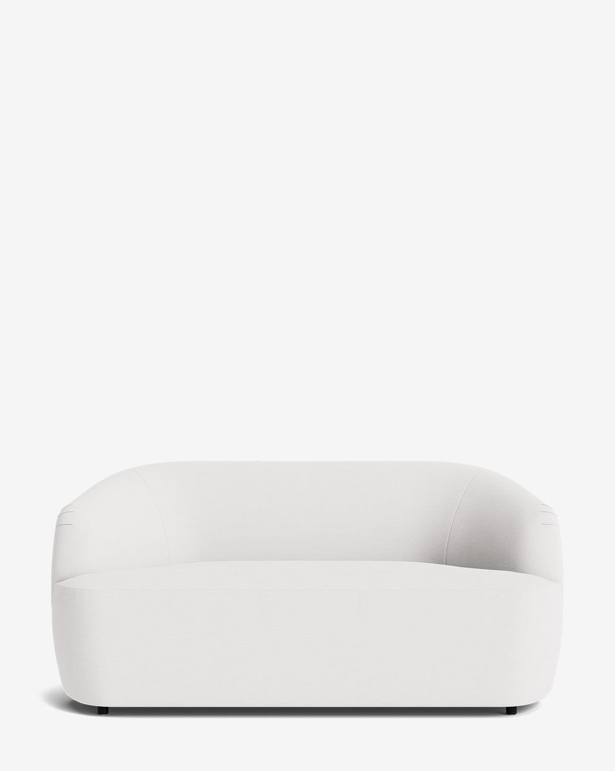 A modern, minimalist Byron Settee 68 in white, featuring rounded edges and a low backrest, set against a plain white background by McGee & Co.