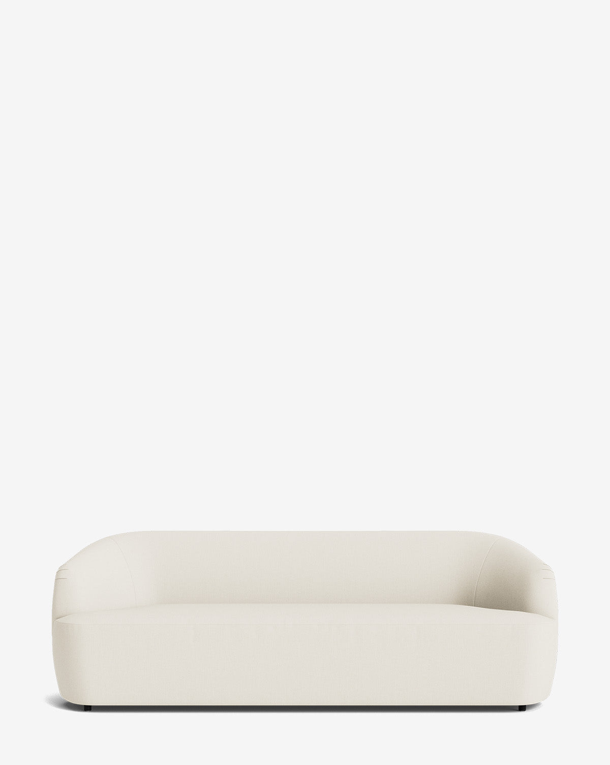 The Byron Sofa 96, in off-white, showcases a modern minimalist design with rounded edges and a low, curved backrest, set against a plain white background by McGee & Co.