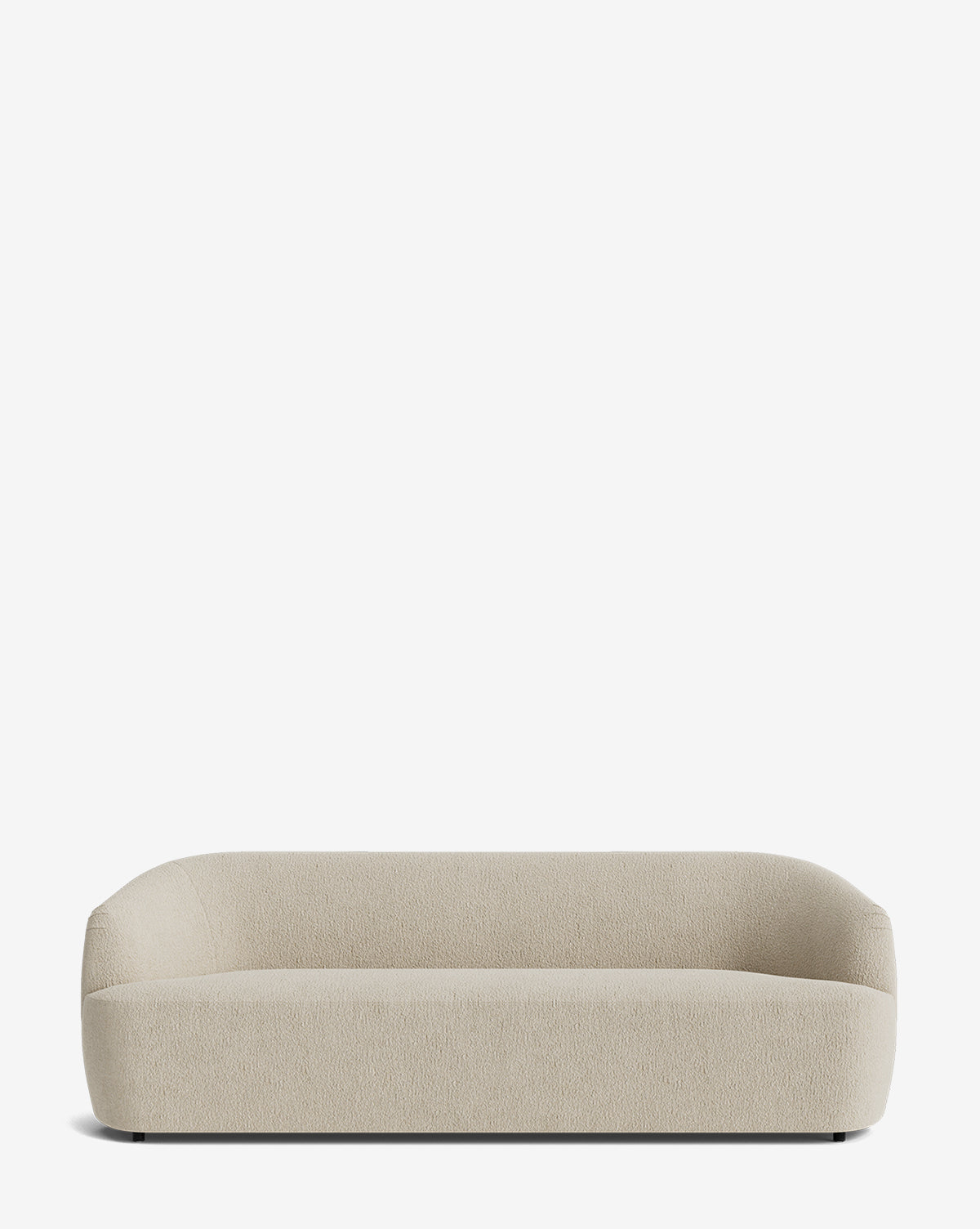 The Byron Sofa 96 is a modern, minimalist beige custom fabric sofa with rounded edges and a low backrest, upholstered in textured fabric and shown against a plain white background, by McGee & Co.