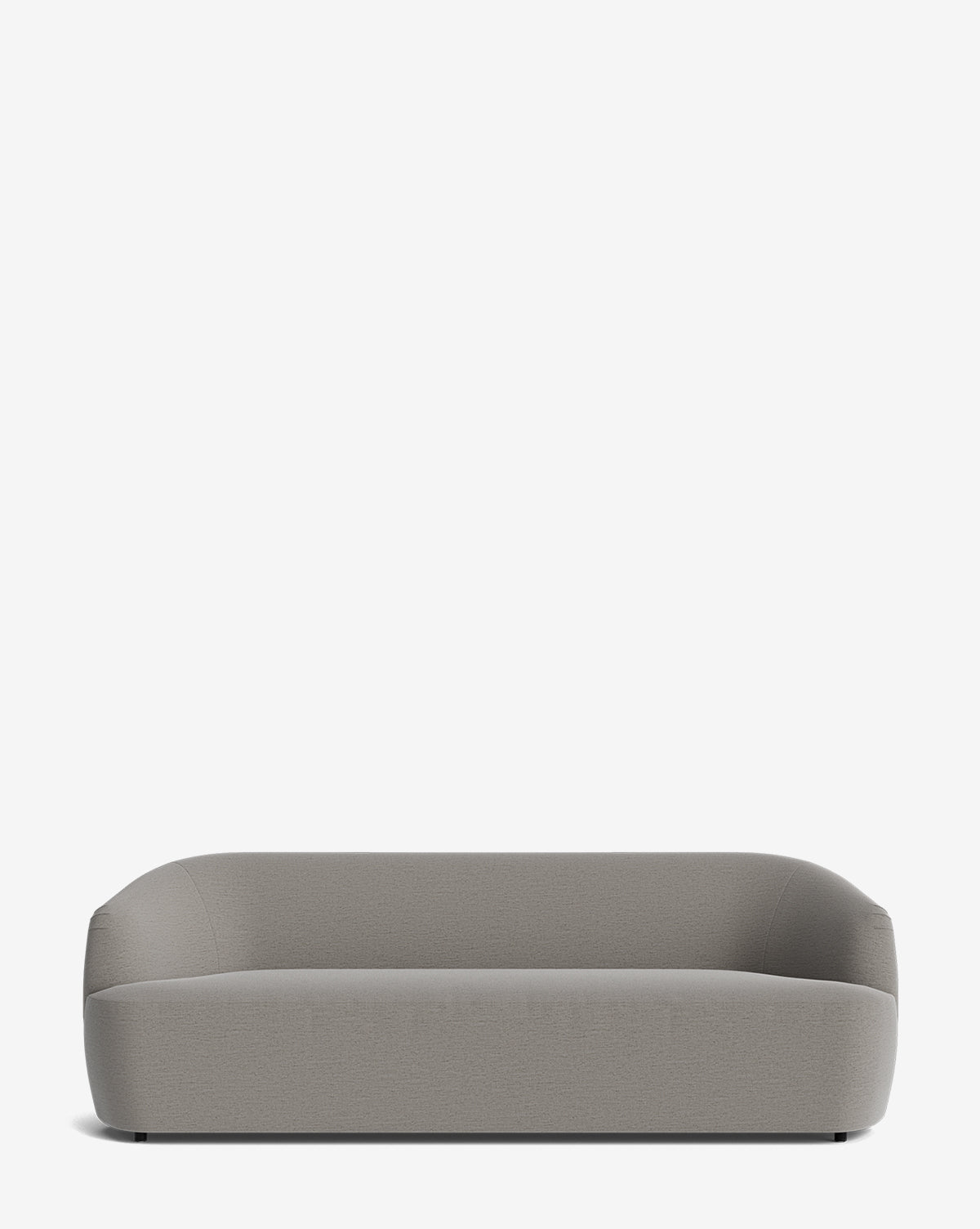 The Makerspalm Byron Sofa 96 features a modern, minimalist design with a curved back, rounded edges, low profile, and light gray custom fabric, shown against a plain white background. McGee & Co.