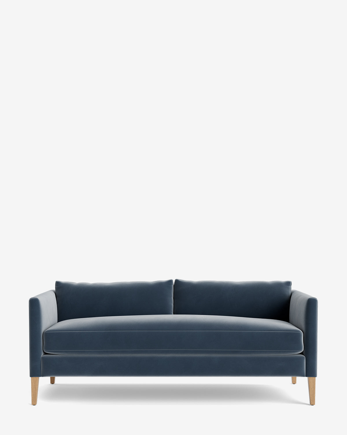 The Cade Sofa 80 is a modern blue velvet sofa featuring a straight back, two large down-wrapped seat cushions, and slim wooden legs, shown against a plain white background by McGee & Co.
