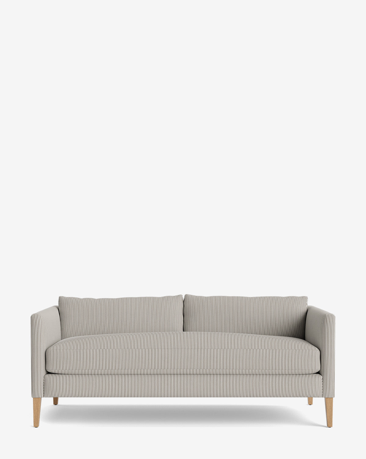 The Cade Sofa 80 features slim wooden legs and light gray and white pinstriped upholstery. This down-wrapped design has straight arms, two back cushions, and a minimalist look, shown against a plain white background by McGee & Co.