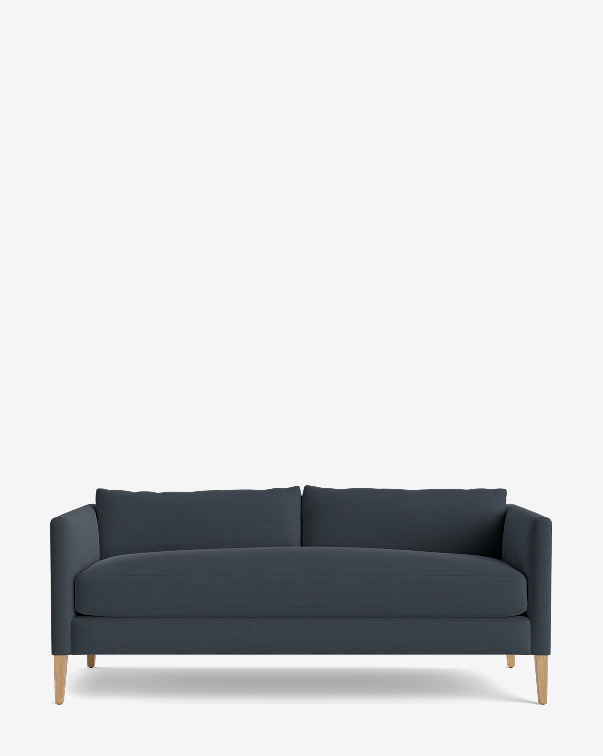 The Cade Sofa 80 is a modern, down-wrapped dark blue sofa with straight arms, two seat and back cushions, and light wooden legs, displayed against a plain white background by McGee & Co.