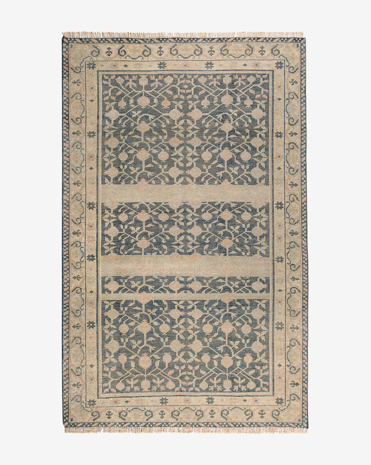 The Campanella Hand-Knotted Wool Rug features a rectangular shape with a detailed, symmetrical floral and vine pattern in dark blue and beige, plus a decorative border and fringe edges inspired by traditional textiles, by McGee & Co.