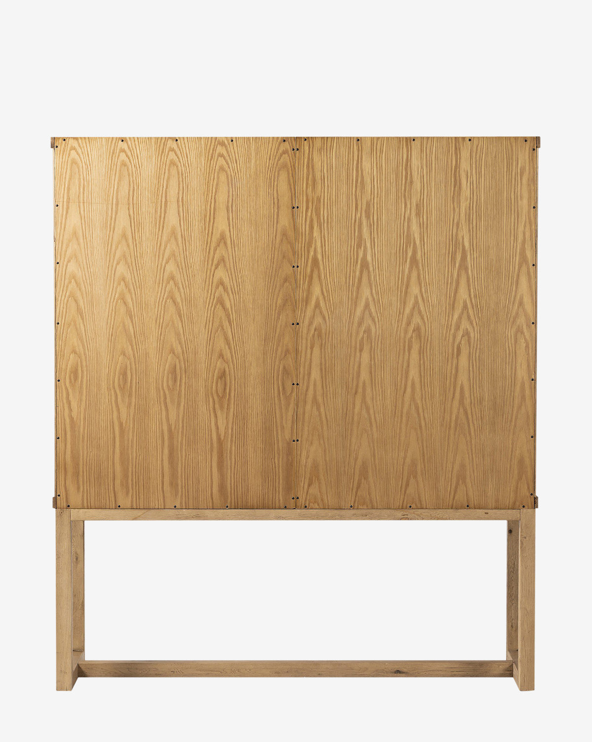 The Carrington Cabinet is a minimalist cabinet with a natural worn oak finish, vertical wood grain patterns, and simple construction on an open rectangular wooden base, by McGee & Co.