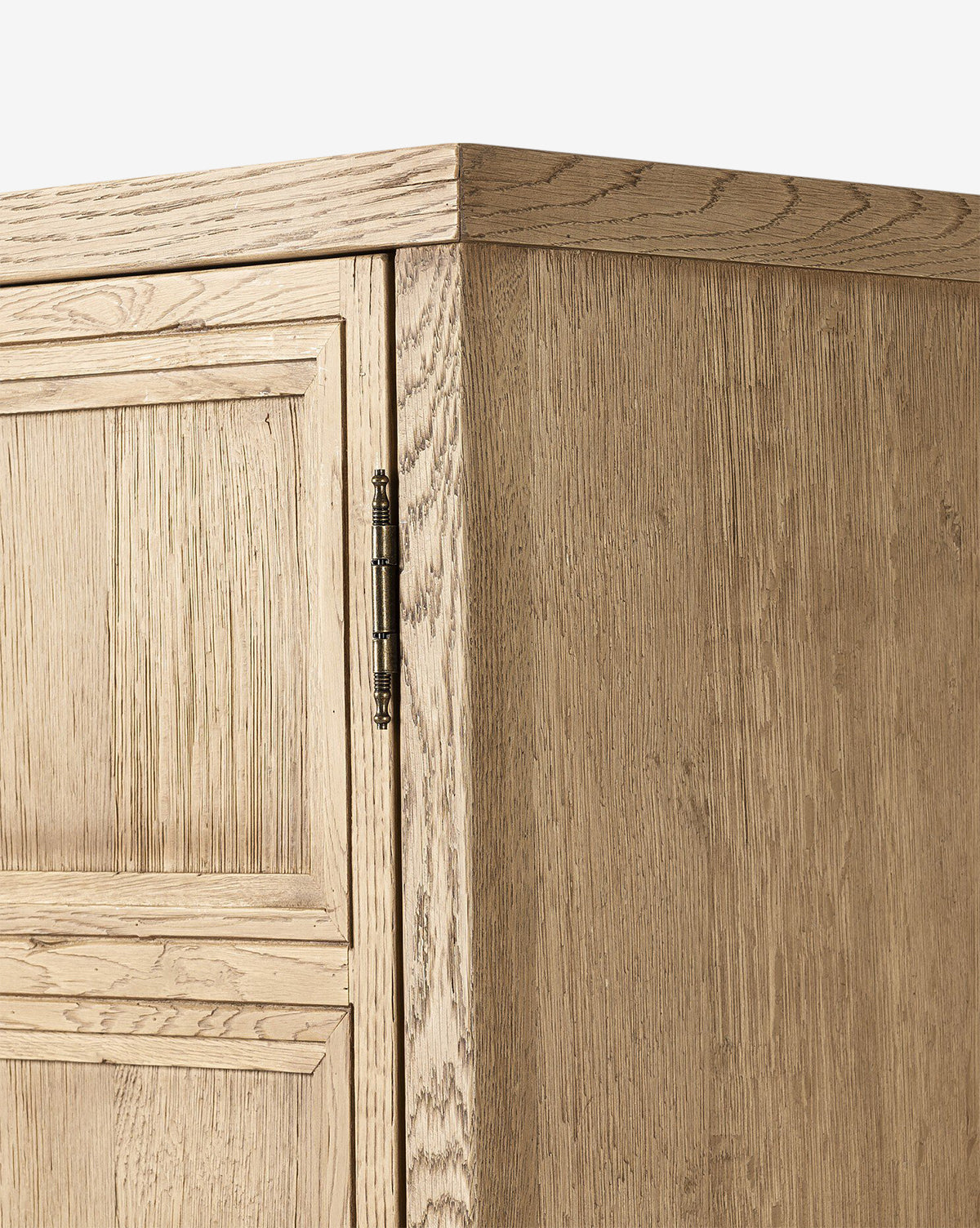 Close-up of the Carrington Cabinet’s corner highlights its bronze-finished hardware and visible wood grain texture in light brown unfinished wood, by McGee & Co.