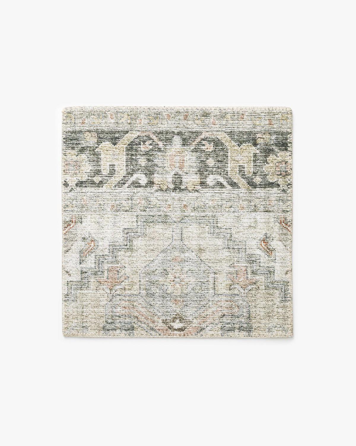 The Cassis Rug Swatch features a square shape with a vintage-inspired geometric and floral pattern in muted shades of gray, beige, and faded green, by McGee & Co.