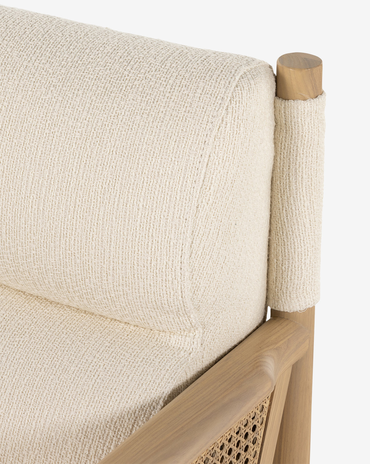 Close-up of the Channing Lounge Chair, showcasing Parisian-inspired design with a wooden frame, woven cane panel, and a high-performance upholstered seat in light beige for added comfort, by McGee & Co.