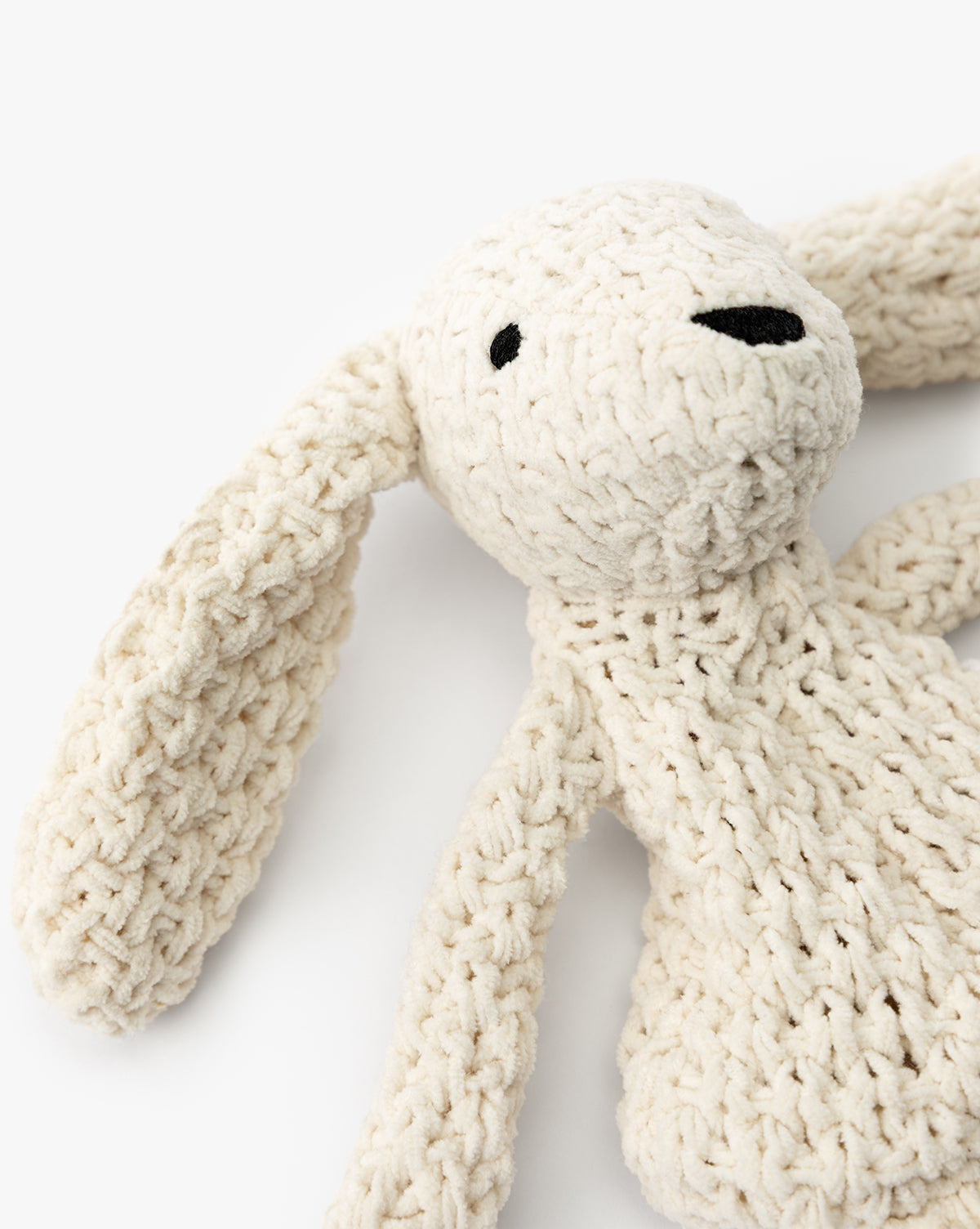 A close-up of ultra-soft Chenille Bunnies (Set of 2), cream-colored with long floppy ears, black embroidered eyes, and a black nose—perfect for nursery decor or cuddling, by McGee & Co. Shown against a plain white background.