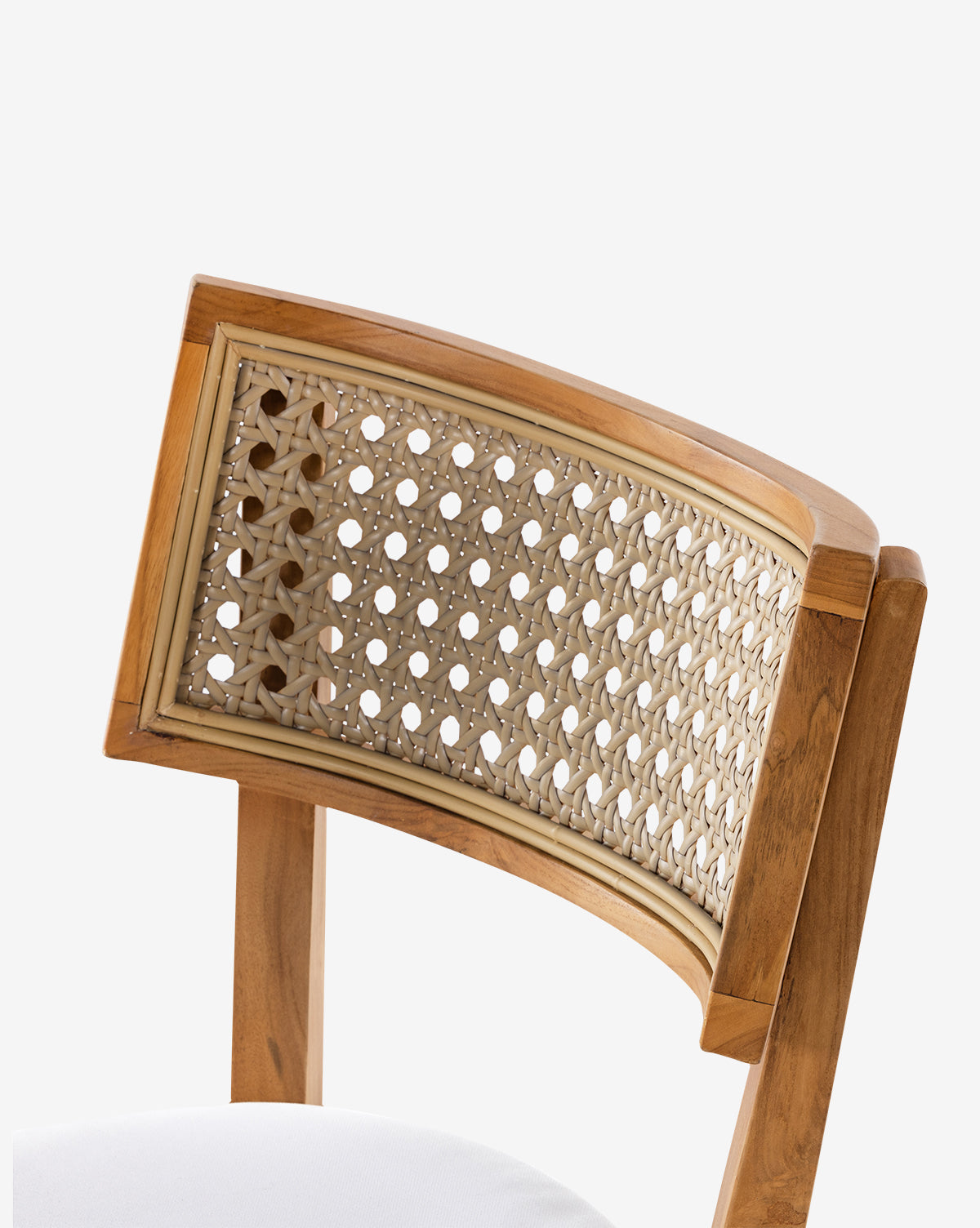 The Chester Outdoor Dining Chair features a sturdy teak frame, a curved backrest with an intricate woven cane pattern, and a white cushioned seat, by McGee & Co.