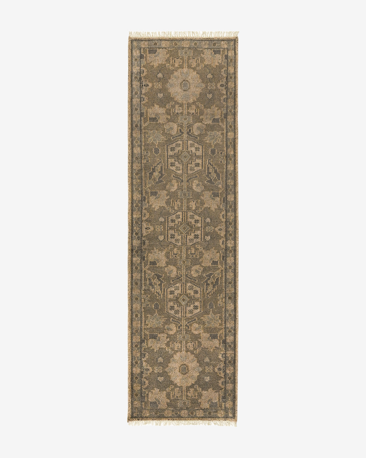 The Chevalier Hand-Knotted Wool Rug is a narrow, rectangular piece with muted earthy-toned geometric and floral motifs, intricate detailing, and fringed edges on both ends, displayed on a light background for timeless elegance by McGee & Co.