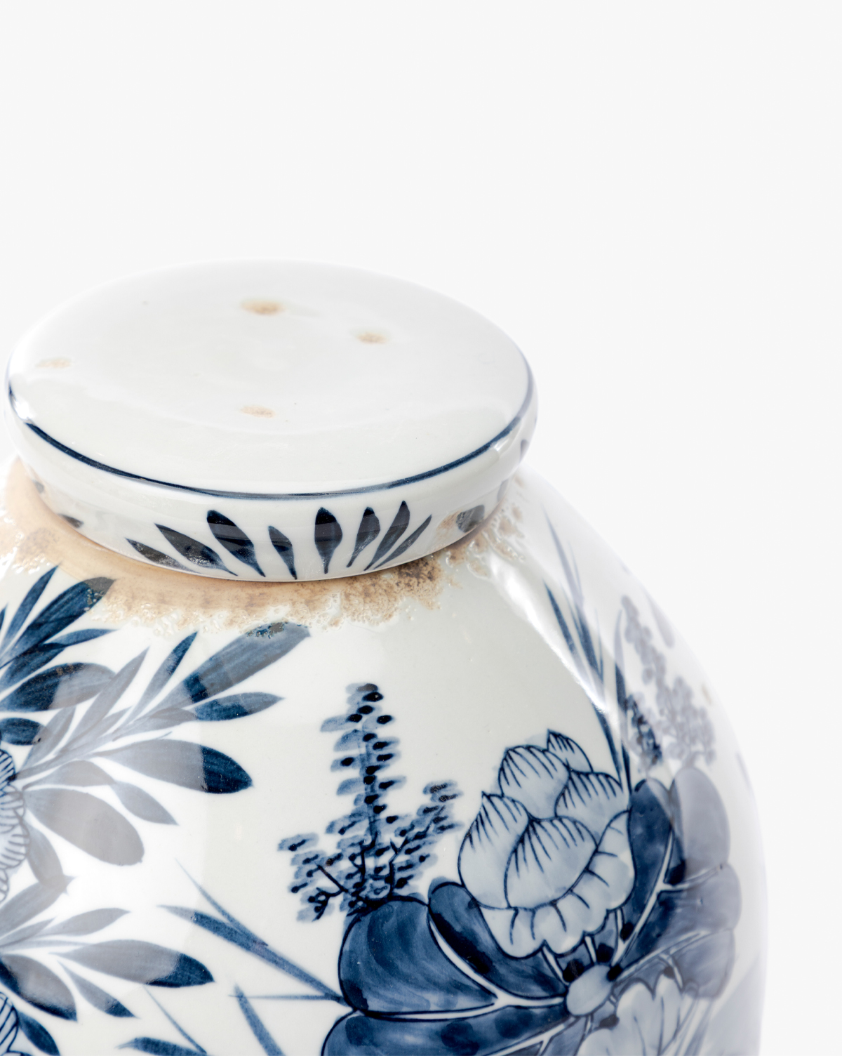 A close-up of the Chinoiserie Ginger Jar, featuring hand-painted blue and white floral patterns and a perforated white lid, set against a plain white background, by McGee & Co.