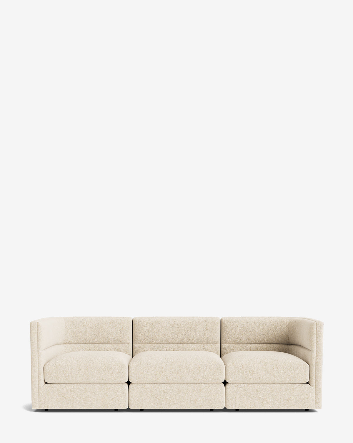 The Claremont Modular Sofa 99 features a modern, vintage-inspired design with a low back, curved armrests, and light beige upholstery, combining luxurious comfort and style against a plain white background, by McGee & Co.