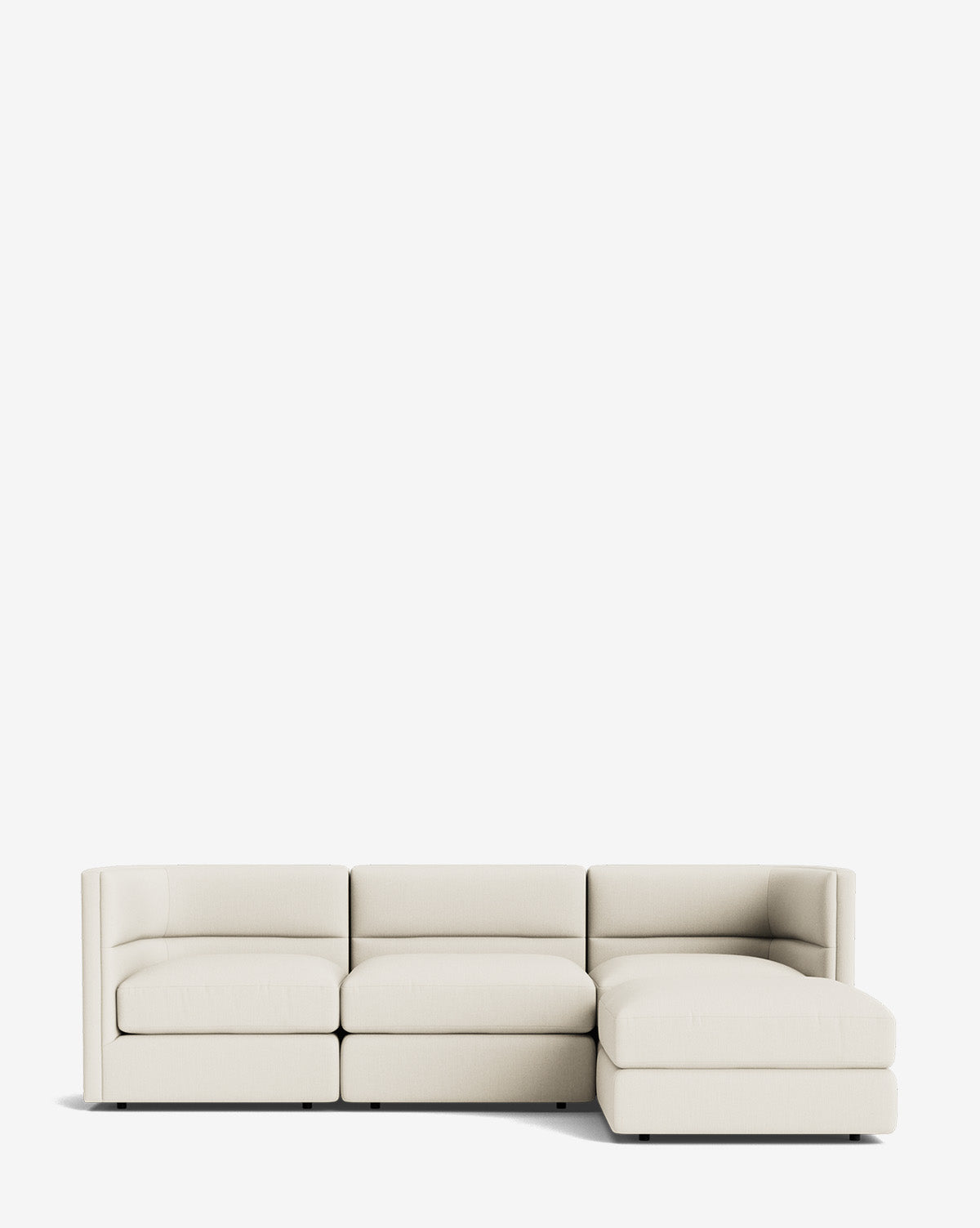The Claremont Modular Sofa with Ottoman 99 in cream features three seat sections, a right-facing chaise lounge, and a channeled back, displayed on a plain white background by McGee & Co.