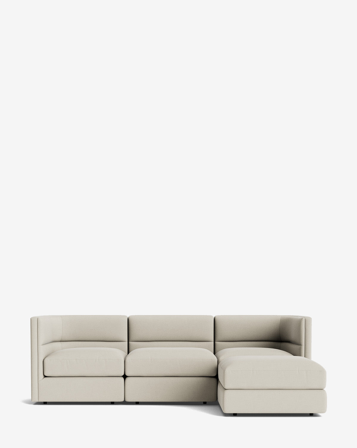 The Claremont Modular Sofa with Ottoman 99 features a modern light beige design, three seat cushions, a right-side chaise lounge, and a sleek channeled back, all set against a plain white background by McGee & Co.