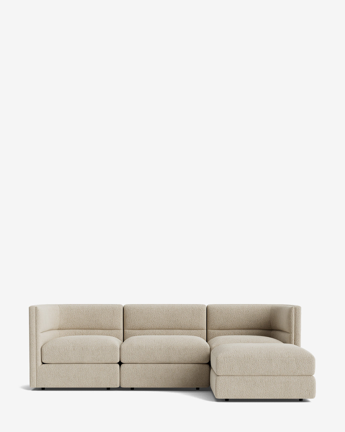 The Makerspalm Claremont Modular Sofa with Ottoman 99 is a modern, light beige sofa with three seat cushions and a right-side chaise, upholstered in textured fabric and shown against a plain white background. McGee & Co.