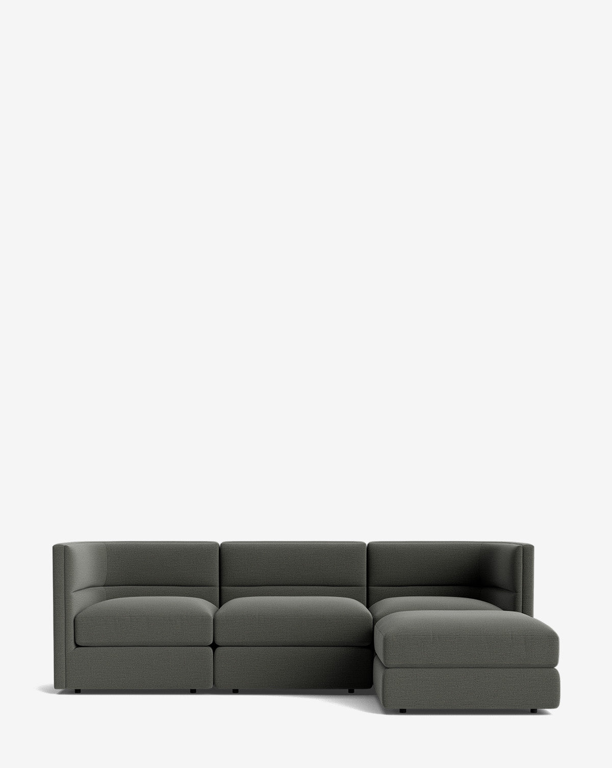 The Makerspalm Claremont Modular Sofa with Ottoman 99 is a modern, dark gray three-seater with a right-side chaise lounge, shown against a plain white background. McGee & Co.