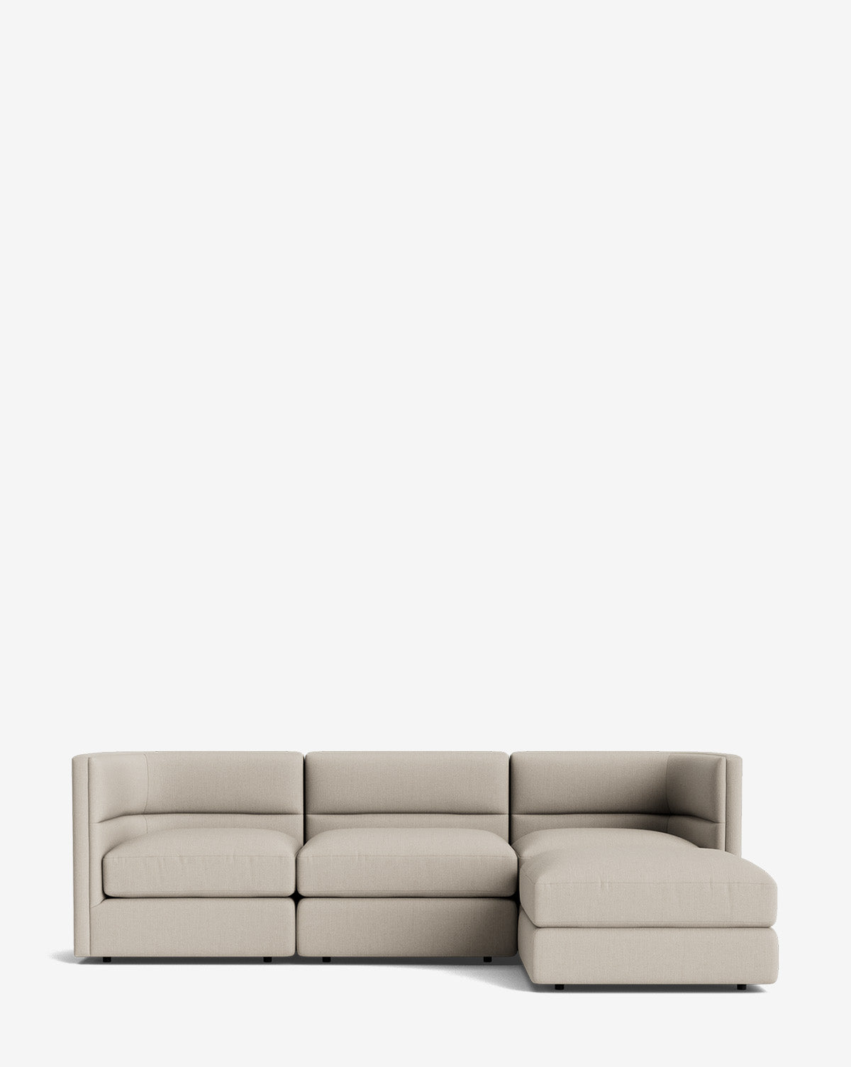 The Claremont Modular Sofa with Ottoman 99 is a modern, light beige three-seater with a right-side chaise lounge and channeled back, shown against a plain white background by McGee & Co.
