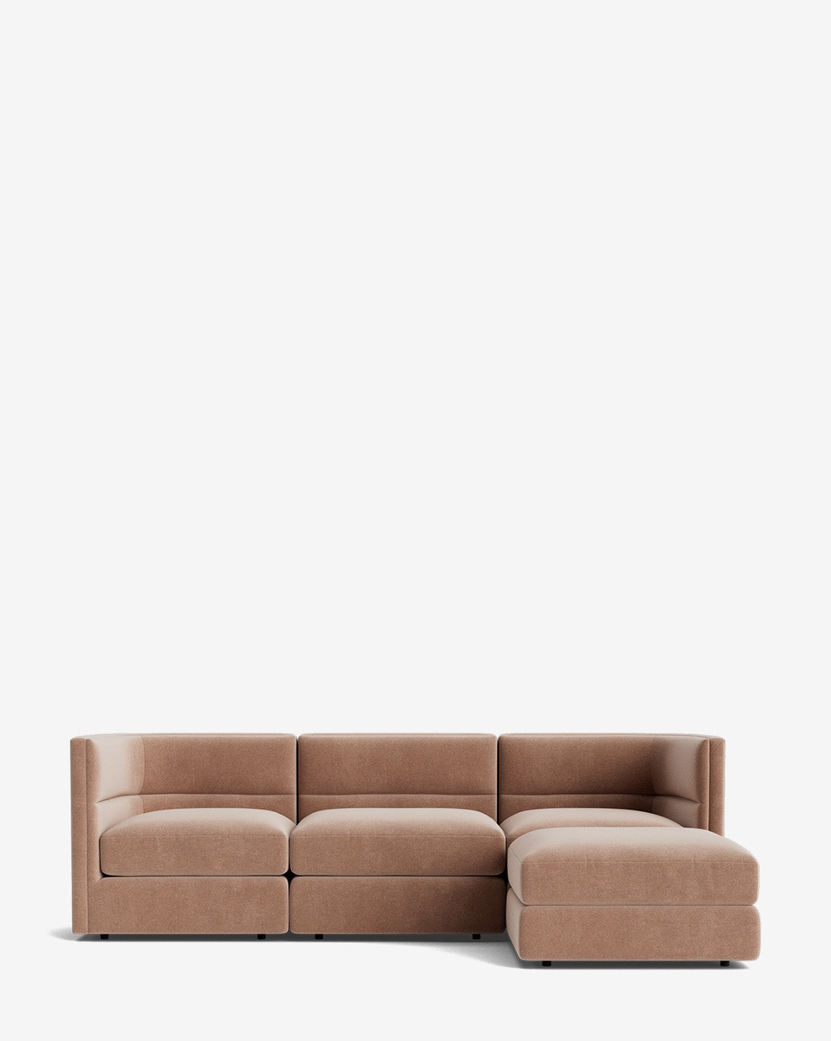 The Claremont Modular Sofa with Ottoman 99 is a modern sectional with low backs, armrests, light brown upholstery, channeled back, three seats, and a right-side chaise lounge, shown against a plain white background by McGee & Co.