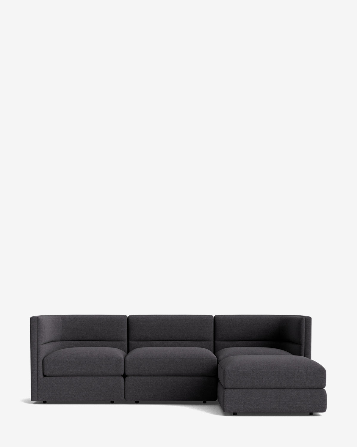 The Makerspalm Claremont Modular Sofa with Ottoman 99 is a modern dark gray sofa featuring three seat cushions and a right-side chaise, displayed against a plain white background. McGee & Co.