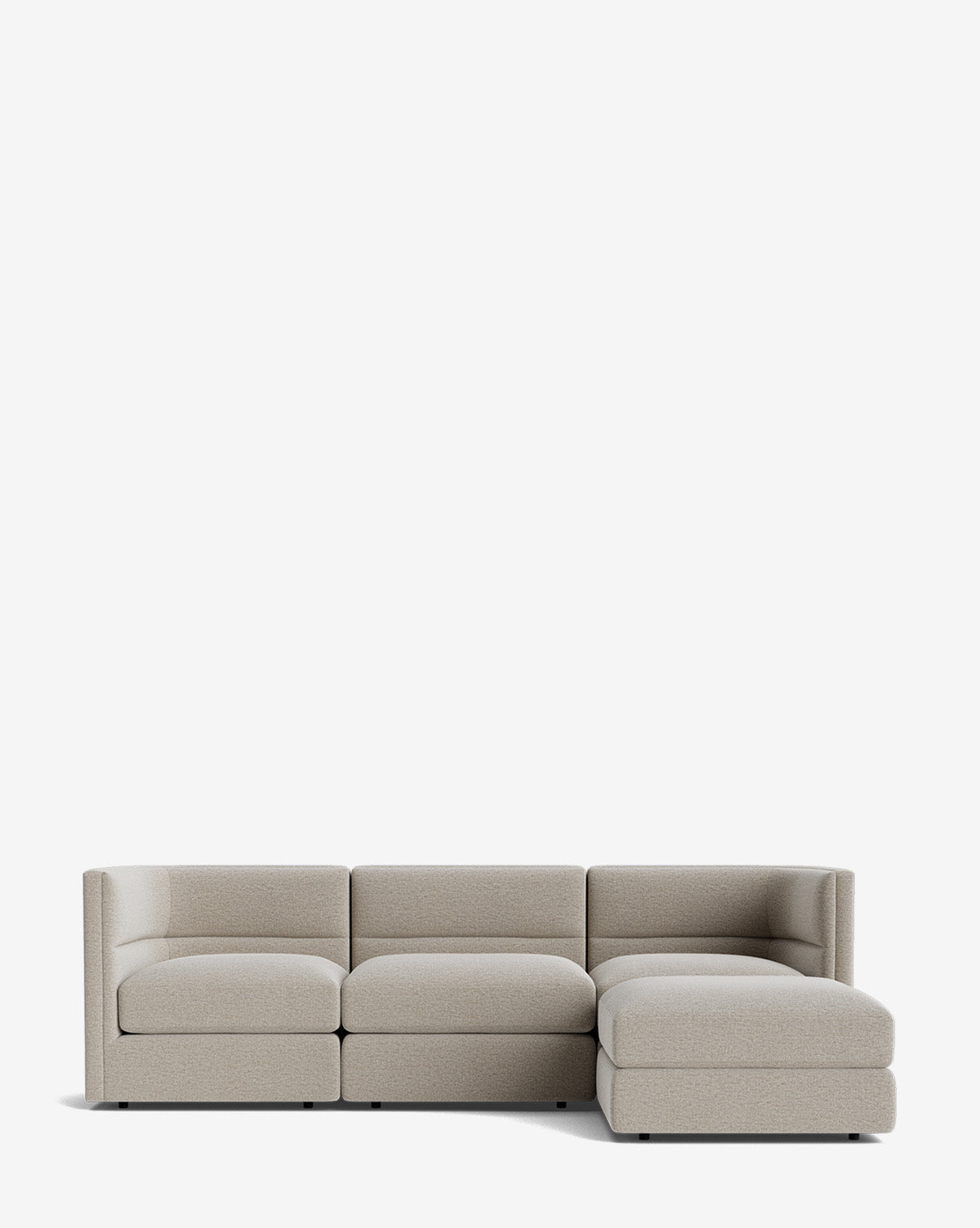 The Makerspalm Claremont Modular Sofa with Ottoman 99 is a modern, light gray three-seater with a right-side chaise lounge, shown against a plain white background. McGee & Co.