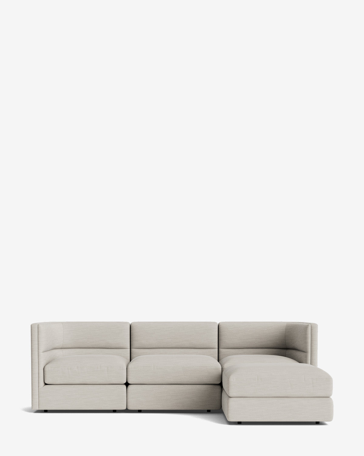 The Claremont Modular Sofa with Ottoman 99 is a modern light gray sofa featuring three seats, a right-side chaise, clean lines, a channeled back, and minimalist style, shown against a plain white background by McGee & Co.