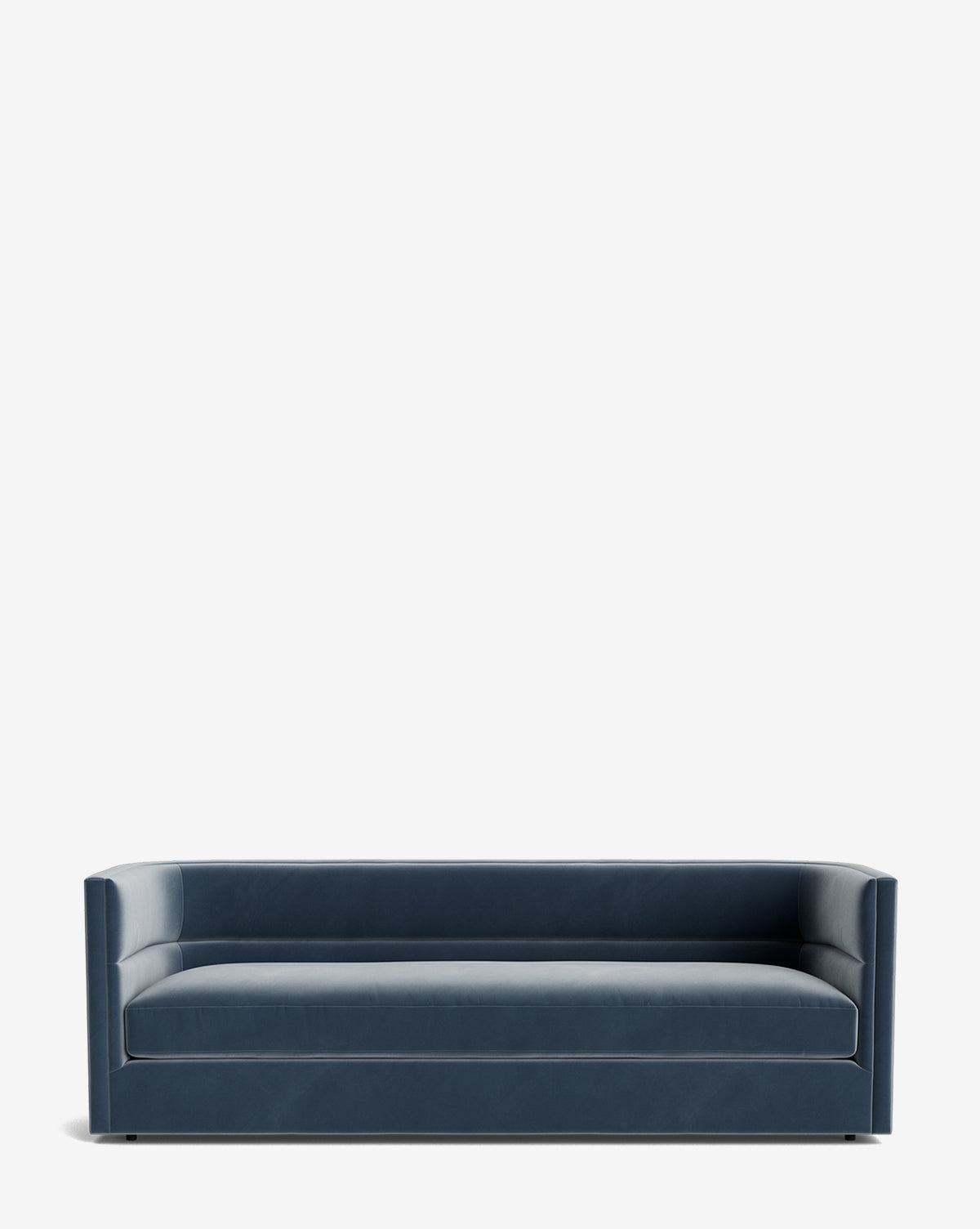 The Claremont Sofa 84 is a modern, dark blue piece featuring clean lines, a low back, and armrests of equal height, crafted from high-quality fabric and showcased against a plain white background by McGee & Co.