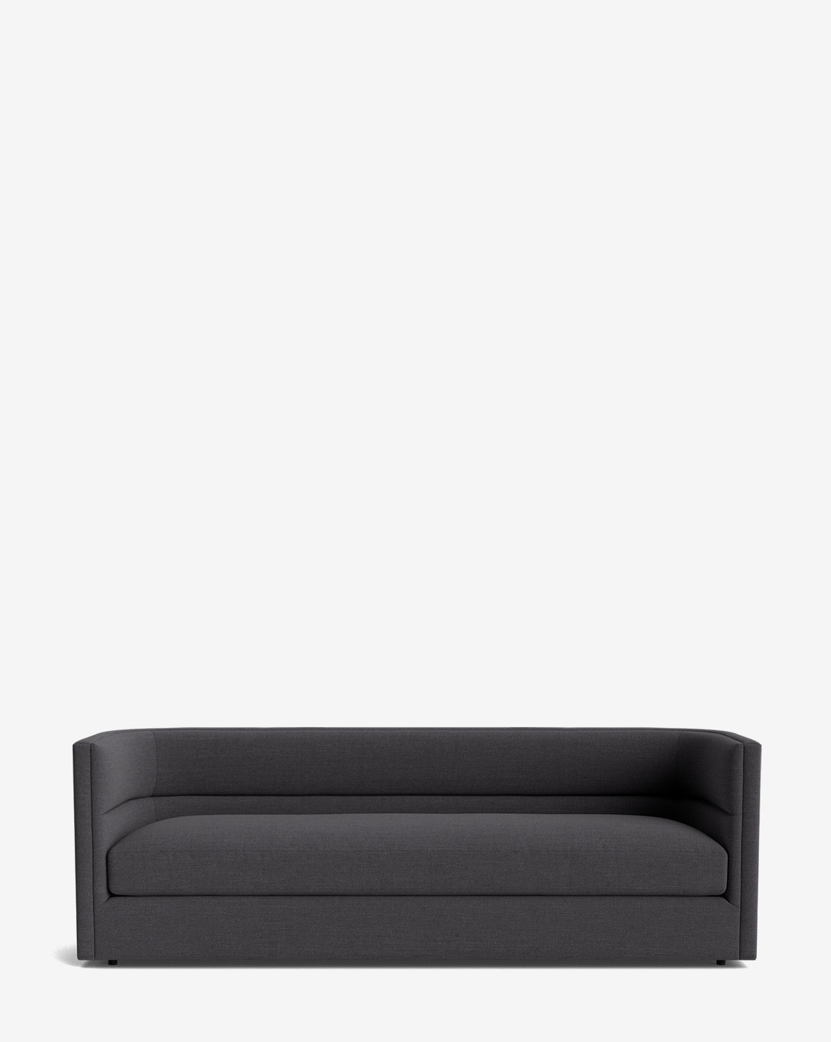 The Claremont Sofa 84 is a modern, dark gray sofa with low, straight arms and a rectangular shape, crafted from high-quality fabric and shown against a plain white background by McGee & Co.