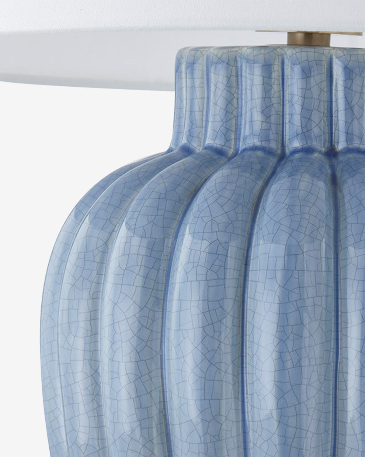 Close-up of the Clarendon Table Lamp, showcasing its blue ceramic base with vertical grooves and crackle glaze, paired with a white lampshade, by McGee & Co.