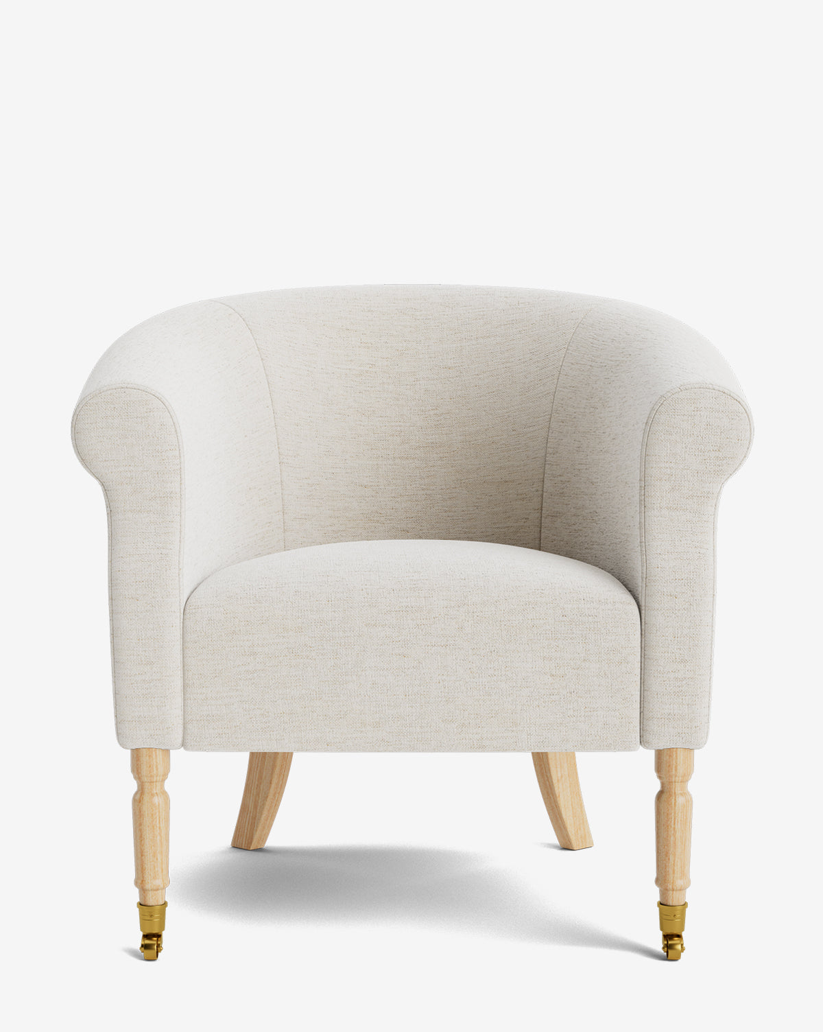 The Clemence Lounge Chair features cream-colored designer fabric upholstery, curved arms, and light wooden legs—two with small brass casters, by McGee & Co. Shown photographed against a plain white background by McGee & Co.