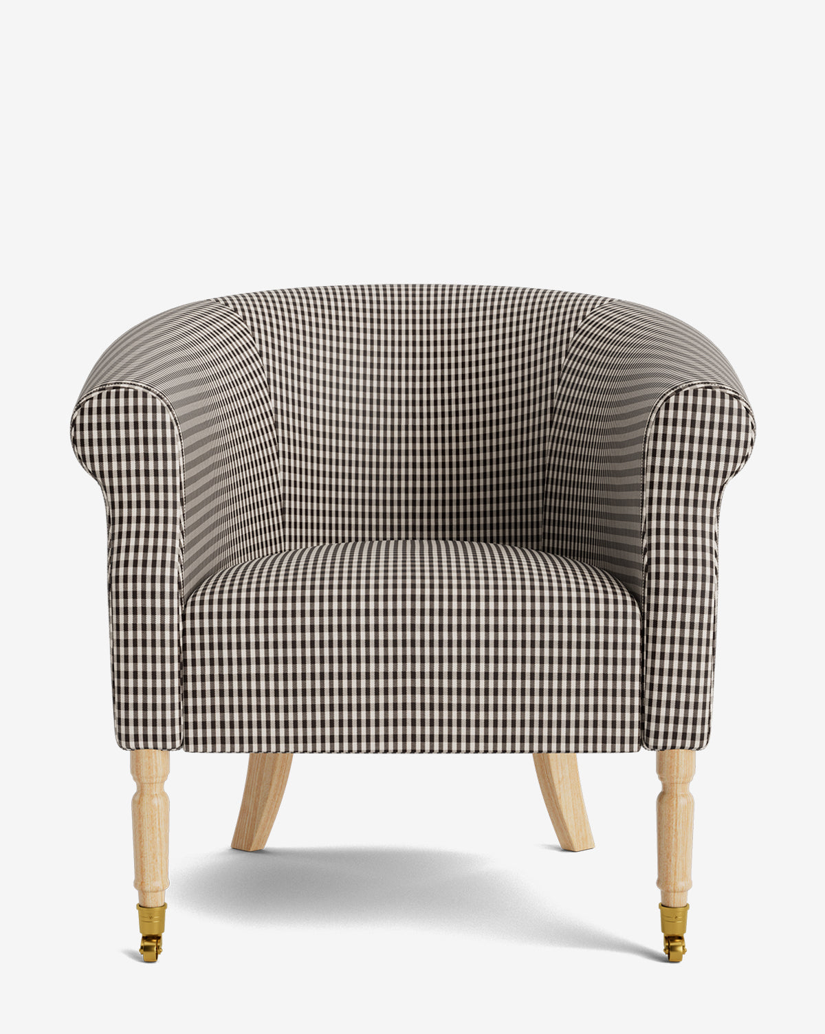 The Clemence Lounge Chair features black-and-white designer fabric, a rounded back and arms, and four light wooden legs—two with brass castors. Set against a white background, it’s a stylish classic for timeless living room interiors by McGee & Co.