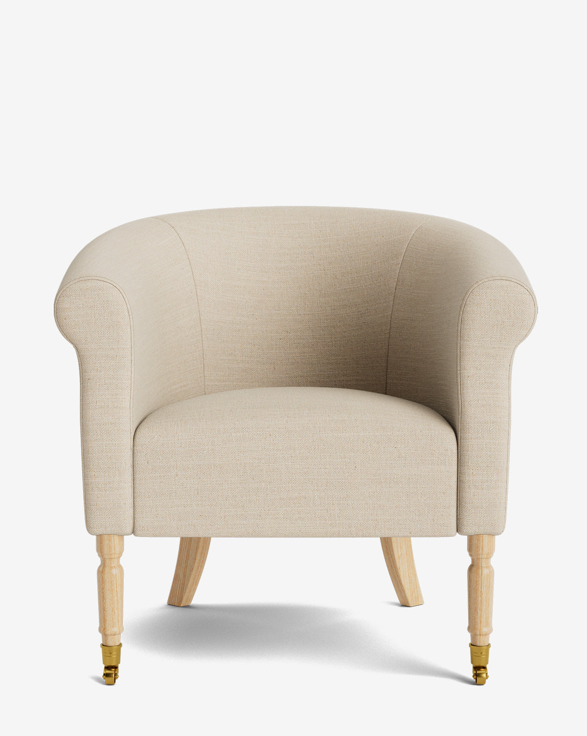 The Clemence Lounge Chair features beige upholstery, rounded arms and back, wooden legs, and brass caster wheels on the front legs, shown against a plain white background by McGee & Co.