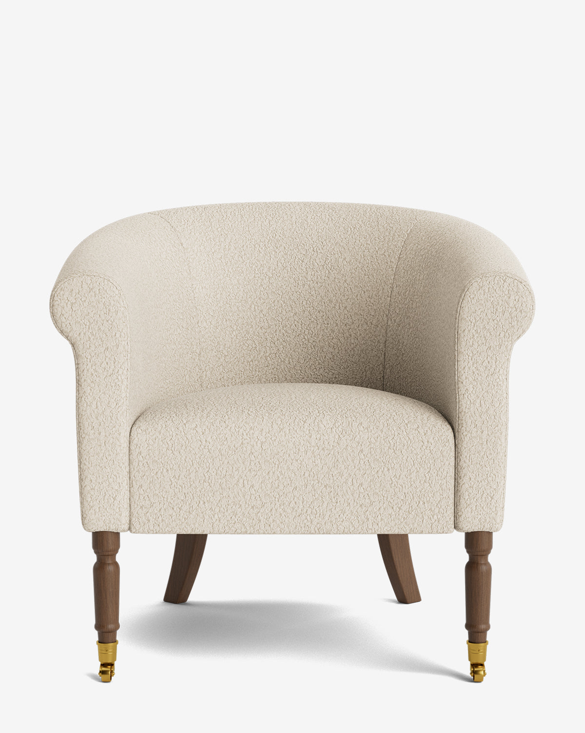 The Clemence Lounge Chair features plush, cream-colored designer fabric, curved arms, and wooden legs—two with brass caster wheels—set against a plain white background by McGee & Co.